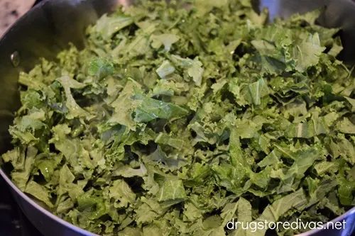 Kale slices in a large skillet.