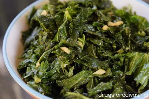 Sautéed Kale and garlic in a white bowl.